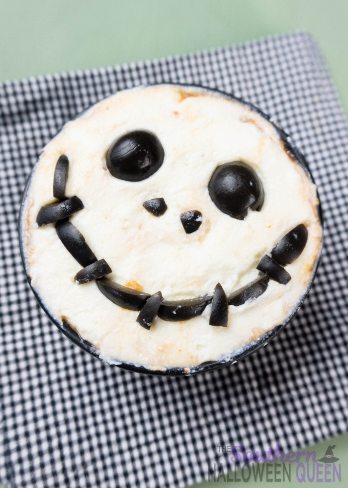 Pizza sauce, pepperoni, ricotta cheese and black olives make up this fun Nightmare Before Christmas Pizza Dip for Halloween or anytime of year!