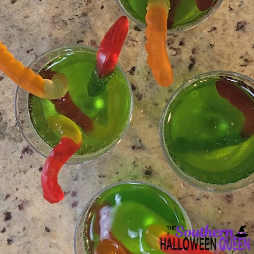 green jello in cups with gummy worms